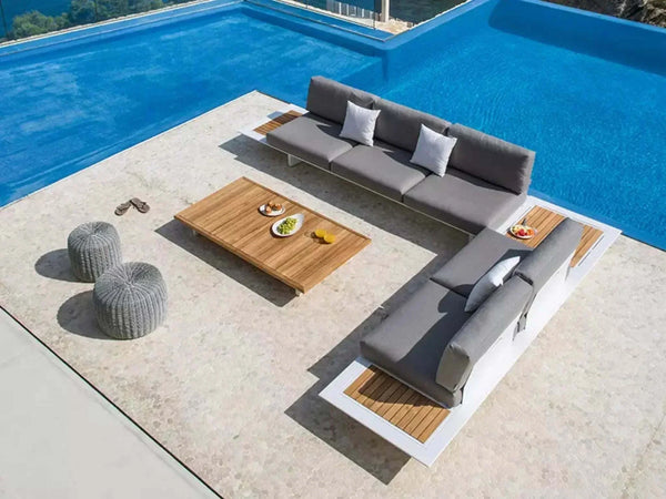 Arbon Outdoor Lounge 3 Seater Sofa with built-in side table by a pool.