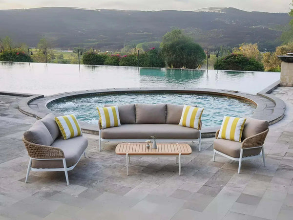 Como 6 Seater Outdoor Lounge Set by a pool on a patio, featuring handwoven wicker and plush cushions.