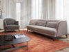 Kart sofa with soft curves, slim legs, and tailored upholstery in a modern interior