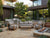 Lincoln outdoor sofa setting with teak frames and grey cushions in a contemporary patio setting