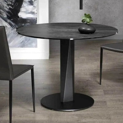 Round Prisma Dining Table with Italian ceramic top and matte black base in modern dining area.