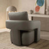 Aria Leather Armchair in gray with sculptural silhouette and sleek armrests, perfect for modern interiors.