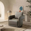 Aria Leather Armchair in modern interior setting with sleek armrests and plush cushioning.