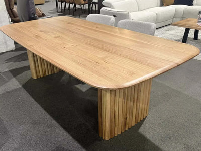 Ashford Dining Table with smooth tabletop and unique pillar-style base.