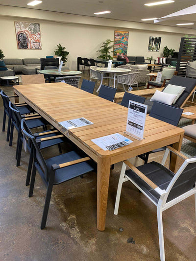 Atoll outdoor teak dining table with black and white rope chairs in showroom Black November Sale