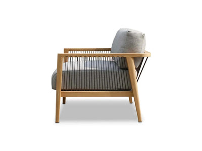 Tribu Outdoor Lounge 1 seater outdoor sofa with teak frame, rope detailing, and grey Sunbrella cushions viewed from the side.