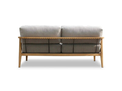 Tribu Outdoor Lounge 2 seater outdoor sofa with teak frame, rope details, and light gray Sunbrella cushions viewed from the back.