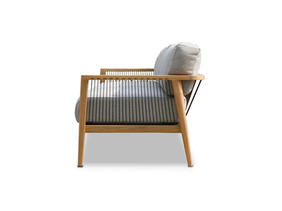 Side view of Tribu Outdoor Lounge 2 seater outdoor sofa with teak frame and gray cushions