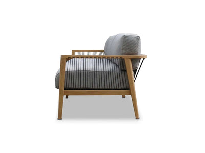 Side view of Tribu Outdoor Lounge 3 Seater Outdoor Sofa with teak frame and grey Sunbrella cushions