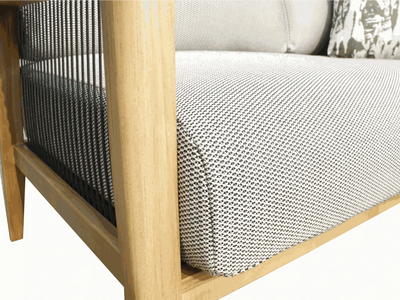 Close-up of Tribu Outdoor Lounge 1 seater outdoor sofa with teak frame, black rope detailing, and patterned Sunbrella fabric cushion