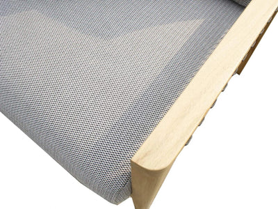 Close-up of Tribu Outdoor Lounge 1 Seater Sofa showing teak wood frame and grey Sunbrella fabric cushion