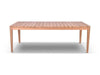 Atoll Outdoor Teak Dining Table with natural A Grade teak and bolt-on legs in outdoor setting
