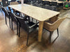 Bella Outdoor Ceramic Dining Table with teak legs and durable ceramic top, set in a modern outdoor dining area.