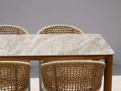 Bella Outdoor Ceramic Dining Table with teak legs and durable ceramic top.