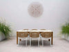 Bella Outdoor Ceramic Dining Table with teak legs in a stylish outdoor setting.