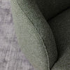 Green textured Bon Armchair on a gray surface.
