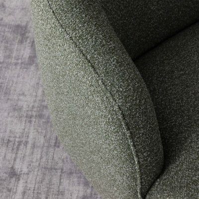 Green textured Bon Armchair on a gray surface.