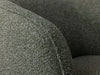 Bon Armchair with textured fabric upholstery in close-up view.
