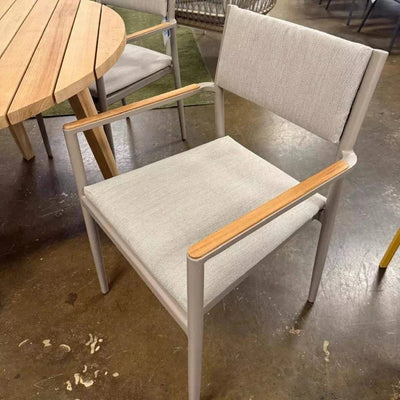 Bonigen Outdoor Dining Chair with aluminum frame, teak armrests, and quick-dry sling seating in a contemporary outdoor setting.