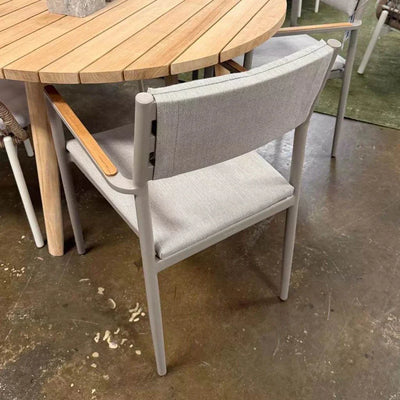 Bonigen Outdoor Dining Chair with aluminum frame, teak armrests, and quick-dry sling seating in a contemporary outdoor setting.