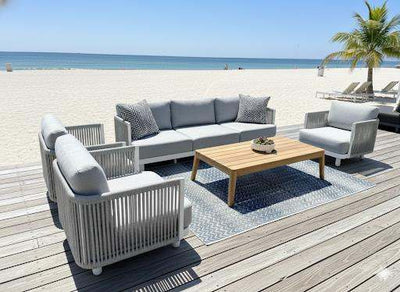 Bonito Outdoor Lounge Set with 3-seater and 1-seater sofas in gray by the beach on a wooden deck.