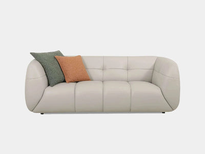 Bric 2.5 Seater Sofa in cream leather with colorful cushions, showcasing a blend of traditional and modern design elements.
