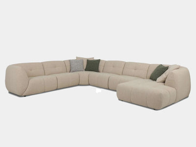 Bric 7.5 Seater Corner Sofa with Chaise in fabric upholstery, featuring plush cushions and modern design elements.