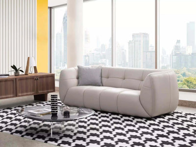 Bric 2.5 Seater Sofa in modern living room, white leather upholstery, city view.