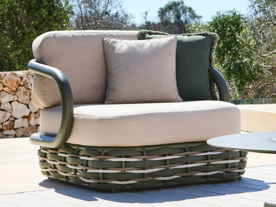 Canasta 1 seater outdoor sofa styled in a contemporary outdoor setting