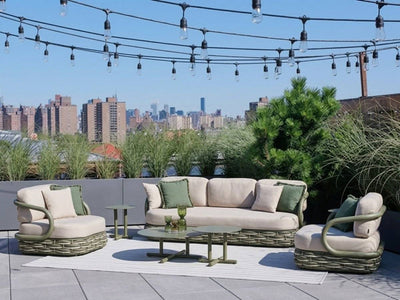 Canasta green outdoor sofa set with lounge chairs on a rooftop terrace