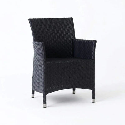 Caribbean Outdoor Dining Chair with handwoven synthetic rattan and powder-coated aluminum frame on patio