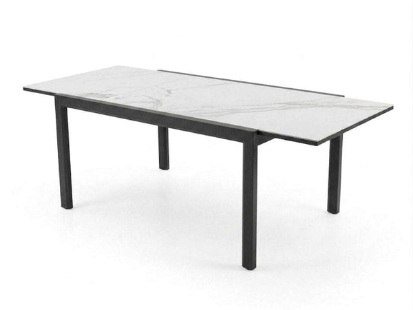 Outdoor ceramic extendable dining table with aluminium base and sleek ceramic top in modern patio setting