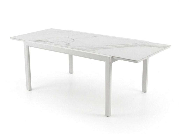 Outdoor ceramic extendable dining table with aluminium base set in garden