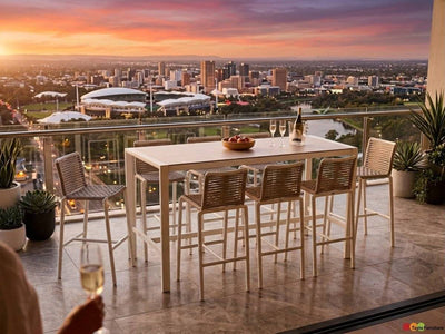 Cebu Outdoor Ceramic Bar Table with white aluminium frame and smooth white ceramic top paired with woven beige bar stools.