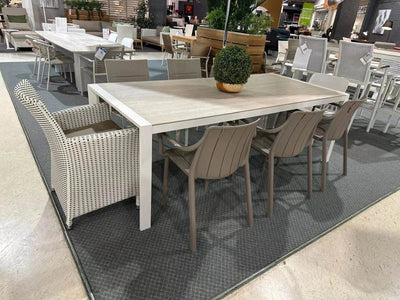 Cebu Outdoor Ceramic Dining Table with chairs in a showroom setting, featuring a durable aluminum base, ceramic top, and modern design.