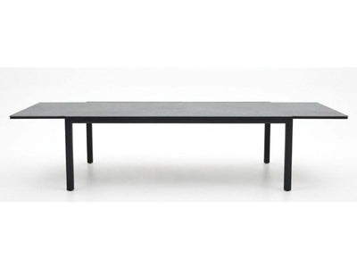 Cebu Outdoor Ceramic Extendable Dining Table - Large with black sleek ceramic top and slim black aluminium legs in extended form.