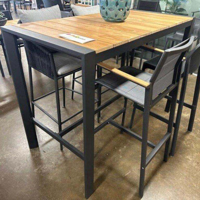 Cebu Outdoor Teak Bar Table with aluminum base and teak top, available in white and charcoal frames.