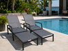 Cebu Sun Lounger with charcoal powder-coated aluminium frame and French Batyline fabric with pull-out footrest by the poolside