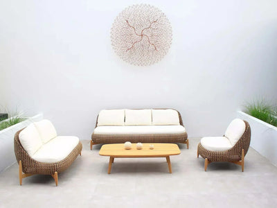 Cloud Outdoor Lounge - 1 Seater Outdoor Sofa with teak legs and Sunbrella cushions in serene patio setting.