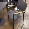 Coco Outdoor Dining Chair with teak armrests and aluminum frame, in a modern outdoor setting.
