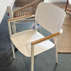 Coco Outdoor Dining Chair in white with teak armrests, sleek aluminum frame, ideal for contemporary patios and terraces.