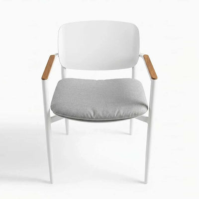 Cove Outdoor Dining Chair with aluminium frame and teak armrests in a modern outdoor patio setting