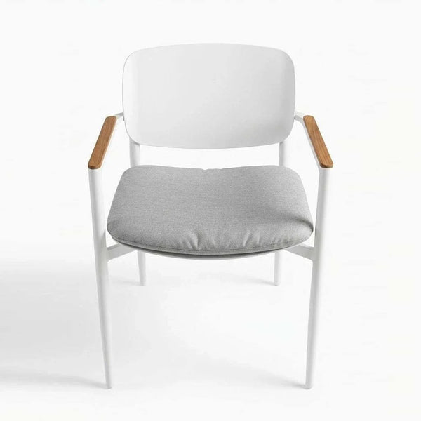 Cove Outdoor Dining Chair with aluminium frame and teak armrests in a modern outdoor patio setting