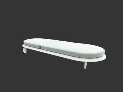 Curve Sun Lounger with white cushions and sleek modern design on dark background