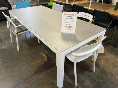 Dante dining table set with six white chairs on clearance sale with cement ceramic top and teak armrest chairs