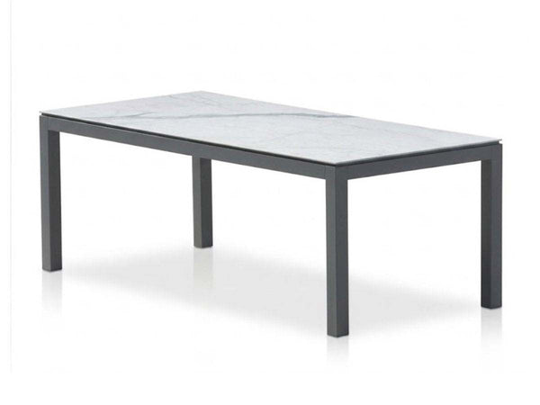 Dante Outdoor Ceramic Dining Table with aluminum frame and ceramic top in outdoor setting