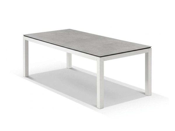 Dante Outdoor Ceramic Dining Table with heavy-duty aluminum frame and easy-to-clean ceramic top in elegant outdoor setting