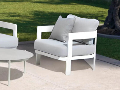 Domani Outdoor Lounge 1 Seater Sofa with white powder-coated aluminum frame and Natte Grey Chine fabric on patio.