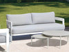 Domani Outdoor Lounge - 2.5 Seater Sofa with white aluminum frame and Natte Grey Chine fabric, placed outdoors.
