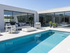 Domani Outdoor Lounge 2.5 Seater Sofa with white aluminum frame and blue cushions by poolside